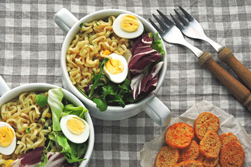 Noodle soup with greens and quail eggs. Flat Lay. Vegan Fitness Lunch.