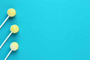 Yellow lollipops on blue background