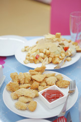 Chicken nuggets with tomato sauce. Party table