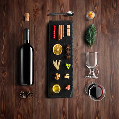 Mulled wine recipe ingredients and kitchen accessories, bottle of red wine, cinnamon, anise stars,...