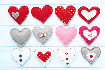 Colorful fabric hearts on wooden table