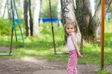 little girl on swing in the park