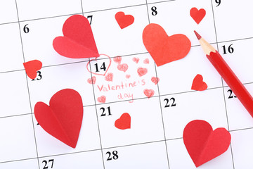 Valentine day calendar with red hearts and red pencil