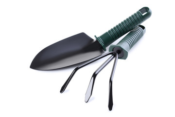 Garden shovel and rake isolated on white background