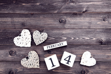 Obraz na płótnie Canvas Valentine day on wooden blocks with grey and white hearts