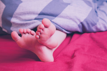 Relax concept. Beautiful groomed bare feet of cute little child girl.