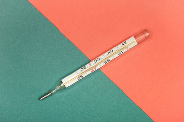 Medical mercury thermometer, Living Coral, trendy color 2019 background.  Free space for text.