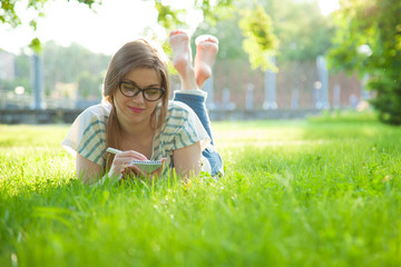 Charming young woman writing in a diary