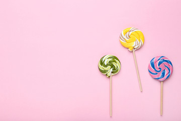 Colorful lollipops on pink background