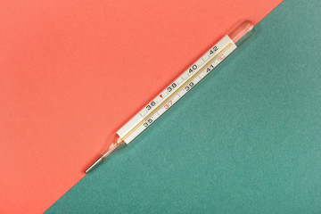 Medical mercury thermometer, Living Coral, trendy color 2019 background.  Free space for text.