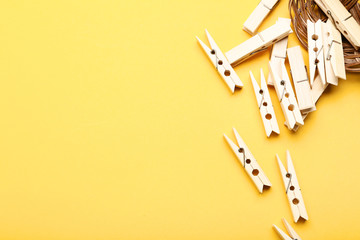 Wooden clothespins on yellow background
