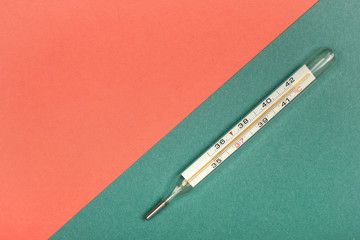 Medical mercury thermometer, Living Coral, trendy color 2019 background.  Free space for text.