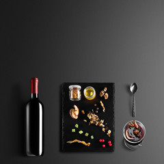 Mulled wine recipe ingredients and kitchen accessories, bottle of red wine, cinnamon, anise stars,...