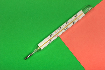 Medical mercury thermometer, Living Coral, trendy color 2019 background.  Free space for text.
