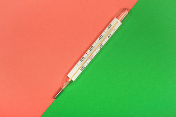 Medical mercury thermometer, Living Coral, trendy color 2019 background.  Free space for text.