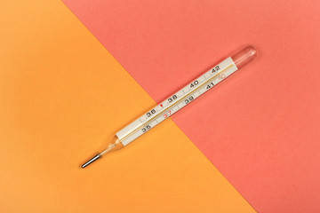 Medical mercury thermometer, Living Coral, trendy color 2019 background.  Free space for text.