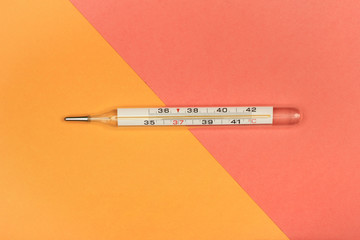 Medical mercury thermometer, Living Coral, trendy color 2019 background.  Free space for text.