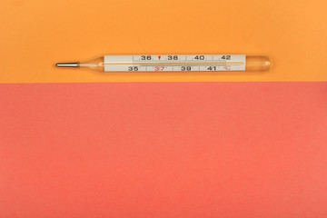 Medical mercury thermometer, Living Coral, trendy color 2019 background.  Free space for text.
