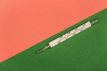 Medical mercury thermometer, Living Coral, trendy color 2019 background.  Free space for text.