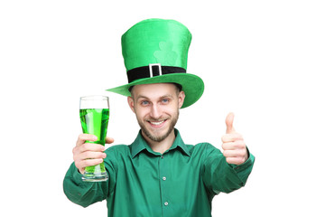 St. Patrick's Day. Young man wearing green hat with glass of beer on white background