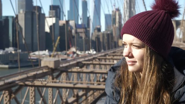 Young happy woman on Brooklyn Bridge in New York