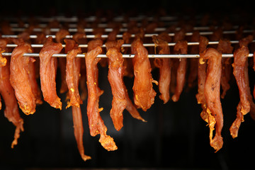 jerky meat in the process of drying on skewers