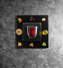 Mulled wine recipe ingredients and kitchen accessories, bottle of red wine, cinnamon, anise stars,...