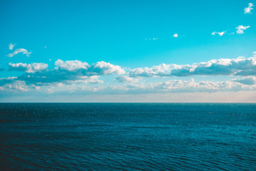 cold colored picture of ocean with beautiful sky and copy space on the top