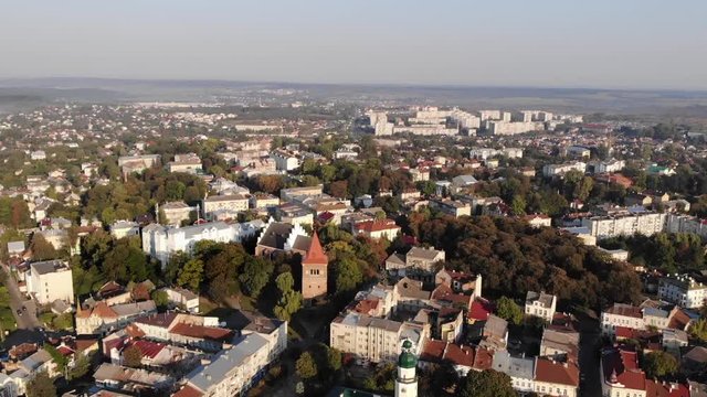 Aerial view of downtown of Drohobych city, Ukraine. Architecture, city hall, central square, cathedral of the Holy Trinity, Church of St. Bartholomew. Smooth flight back