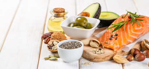 Fototapeta Selection of healthy unsaturated fats, omega 3 - fish, avocado, olives, nuts and seeds obraz