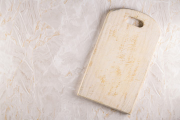 Wooden cutting board on a gray marble background