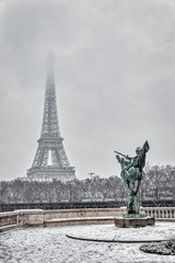 Snowfall over France Reborn Statue on Pont de Bir-Hakeim with Eiffel tower in background.