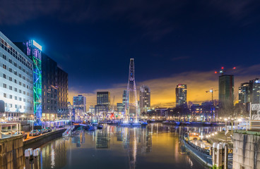 Harbor basin in Rotterdam before sunrise. 
Beautiful reflection of Rotterdam´s skyline in the harbor basin. Colorful cityscape