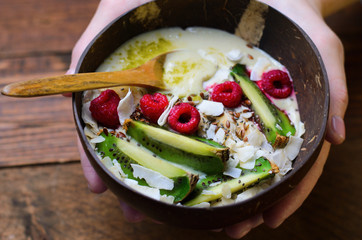 Smoothie Bowl Topped with Raspberry, Kiwi, Chia, Flaxseed and Coconut