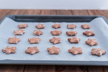 Star shaped ginger cookies on baking tray.