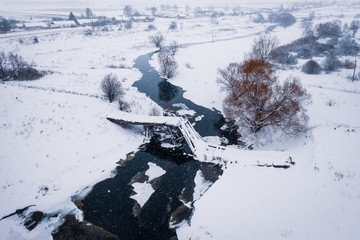 Broken bridge over the river. Winter landscape. Russia.