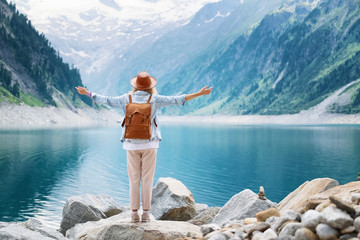 Traveler-Image. Traveler look at the mountain lake. Travel and active life concept. Adventure and travel in the mountains region in the Austria.