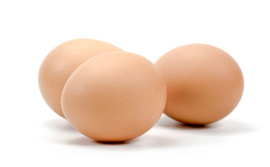 three chicken eggs on a white background