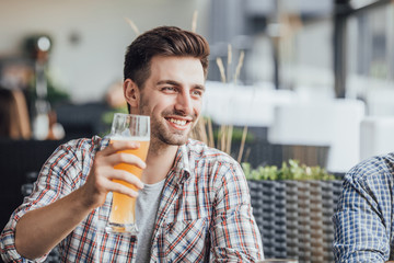 Fototapeta premium Yong beautiful man drinking beer after hard work