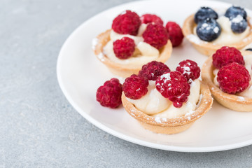 tartlets or cake with cream and  berries. Pastry dessert.
