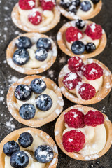 Homemade cakes with berries on  gray background close-up