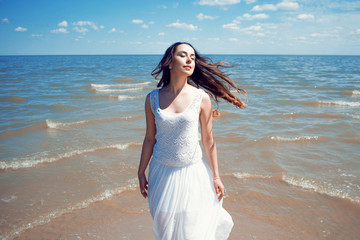 Fototapeta na wymiar Young beautiful brunette woman in white dress