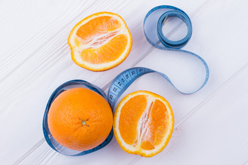 Oranges fruits and measuring tape. Healthy diet for weight loss. High vitamin C food.