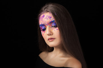 Attractive brunette with bright art make-up. Colored Smokey eyes and blue eyebrows.