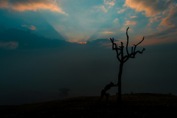 SILHOUETTE OF WOMAN AT SUNRISE