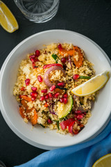 Healthy vegetarian couscous with roasted vegetables on black background. close up. top view. vertical