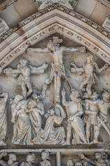 Crucifixion of Christ scene at major entrance portal of Saint Vitus Cathedral in Prague, Czech Republic, details, closeup