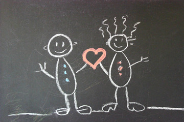 The concept of love, family. Two people in love are drawn with chalk on a black school Board. Valentine's day. First love. Copy space
