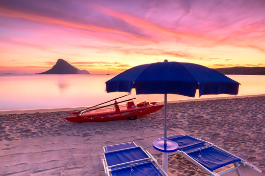 Amazing sunrise on the beach of Porto Taverna with the Tavolara Island in the background, Loiri Porto San Paolo, Olbia Tempio province, Sardinia, Mediterranean