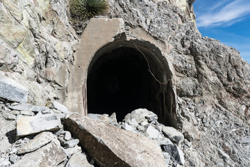 Partially collapsed entrance and rock slide damage at Mueller Tunnel in the San Gabriel Mountains...